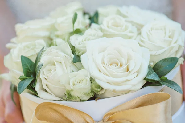 Bridesmaid holding a box of roses. Rose box. Beautiful gift with white roses.