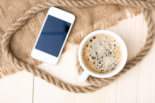 Cup of coffee with foam on wooden table — Stock Photo, Image