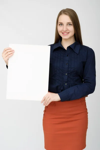 Happy woman holding white blank paper — Stock Photo, Image