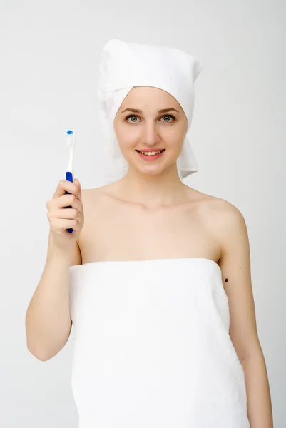 Beautiful woman with a great smile holding toothbrush, isolated over a white background — Stock Photo, Image