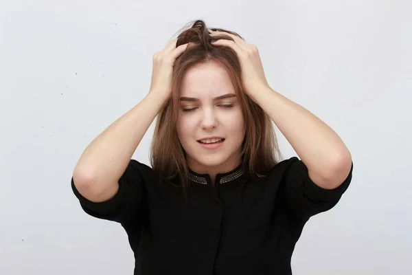 Mladá žena má bolesti hlavy, izolované na šedém pozadí — Stock fotografie