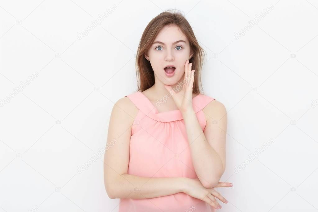 Young casual woman In pink blouse isolated over white background studio portrait