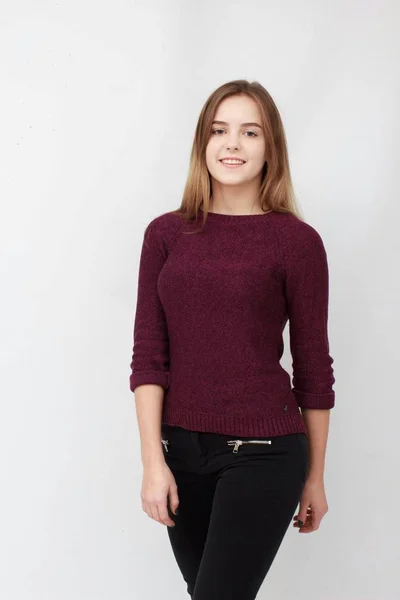 Portrait of a young attractive woman in red sweater — Stock Photo, Image