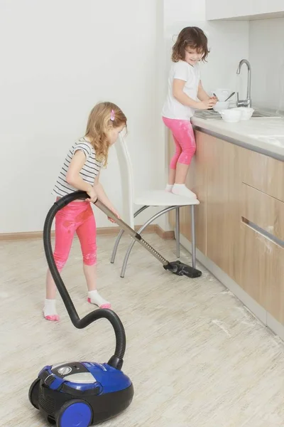 Little beautiful smiling girl running with vacuum cleaner at home. — Stock Photo, Image