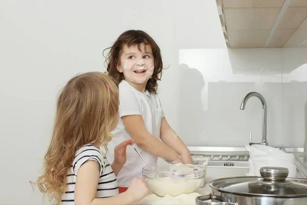 Madre con sus hijos de 5 años cocinando pastel de vacaciones en la cocina — Foto de Stock