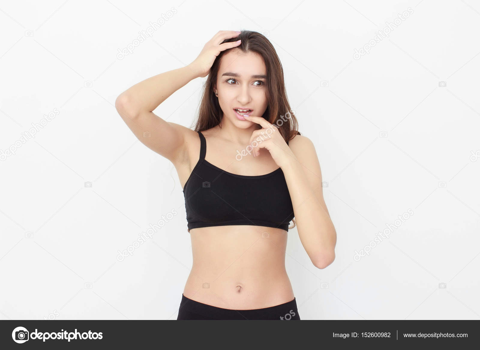 Beautiful girl in black top on white background shows emotion Stock ...
