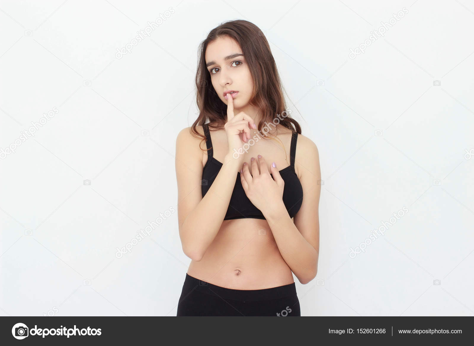Beautiful girl in black top on white background shows emotion Stock ...