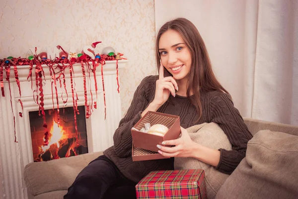 Smiling woman holds christmas tinsel — Stock Photo, Image