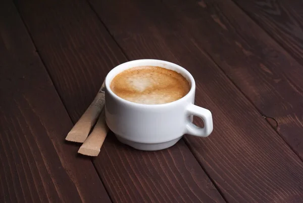 Šálek kávy na dřevěném pozadí — Stock fotografie