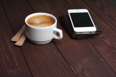 Fincan kahve smartphone ve m-cüzdan ile ahşap arka plan üzerinde