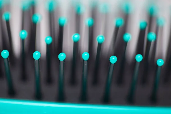 Macro view of hairbrush with blue head — Stock Photo, Image