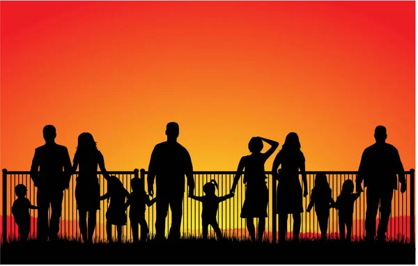 Silhouette della famiglia al tramonto . — Vettoriale Stock