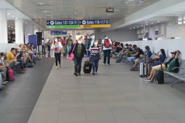 Manila, Philippines- February 11, 2020: Passengers at the Ninoy Aquino International Airport, wear medical masks for protection against the coronavirus outbreak.