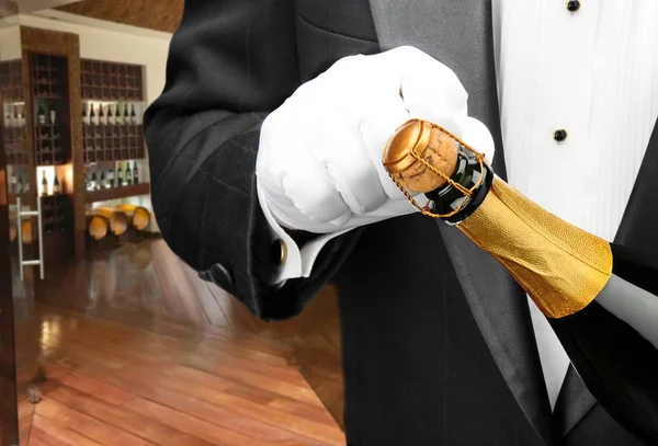 Waiter opening bottle of champagne — Stock Photo, Image