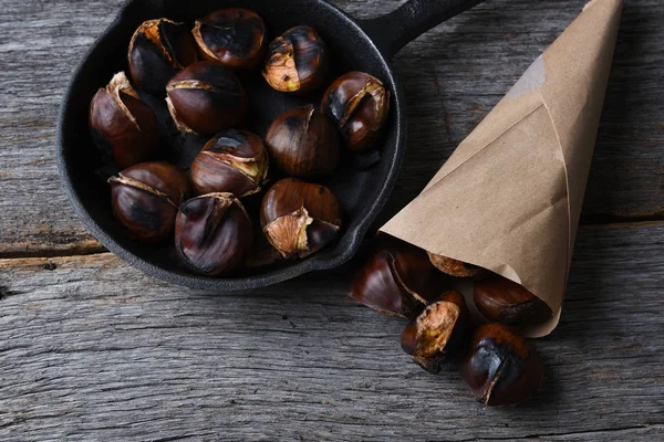 Roasted chestnuts in Pan and a Paper Sack — Stock Photo, Image