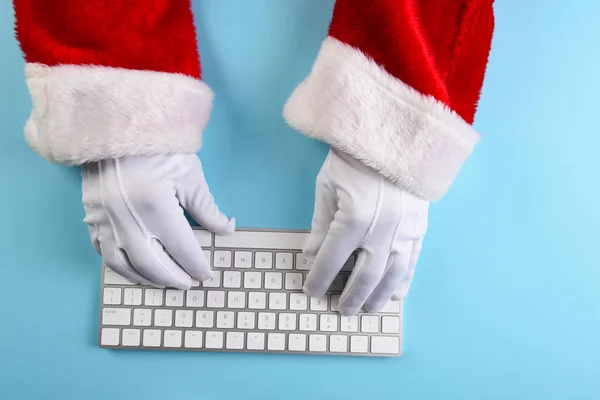 High angle closeup of Santa Claus hands using his computer keybo — Stock Photo, Image