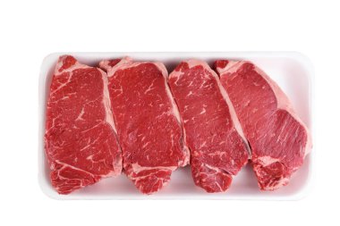 Four Boneless Beef Loin New York Steaks in a styrofoam tray isol clipart