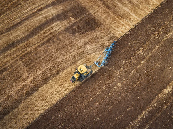Tractor cultivating field at autumn — Stock Photo, Image