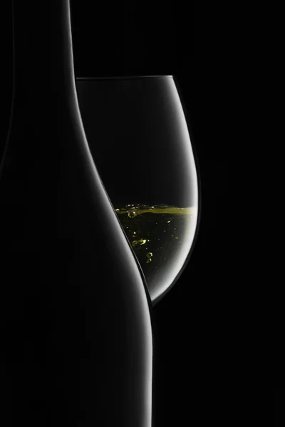 Bottle and glass of white wine on a black — Stock Photo, Image