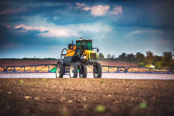畑に耕し散布する農業用トラクター — ストック写真