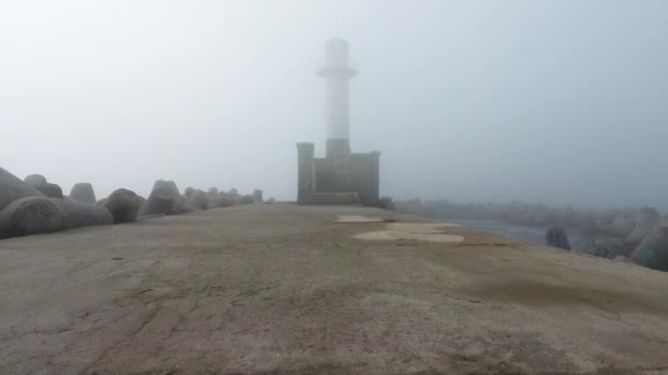 Sunrise over Lighthouse in dense fog and mist, aerial view — Stock Video