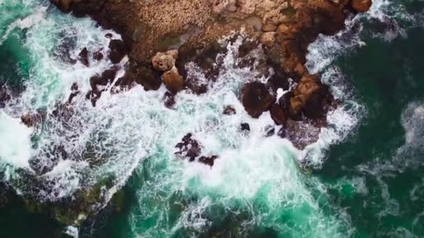 Вид з повітря на скелясту берегову лінію і падаючі хвилі на скелі — стокове відео