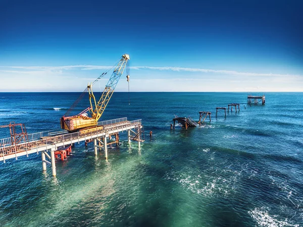 Aerial view of work crane on the broken bridge — Stock Photo, Image