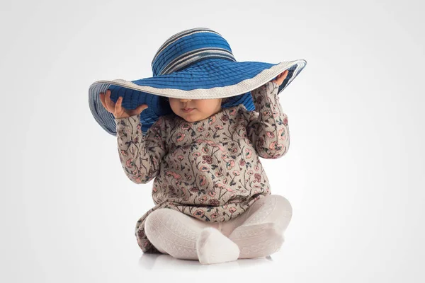 Happy little girl wearing mothers hat, isolated — Stock Photo, Image