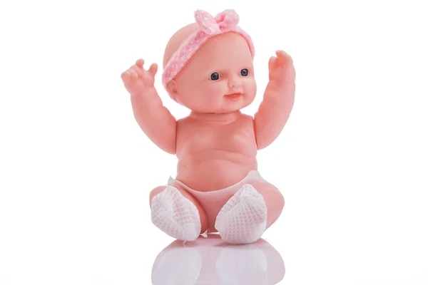 Bonitinho boneca de plástico pequeno com olhos azuis sentados isolados no fundo branco — Fotografia de Stock
