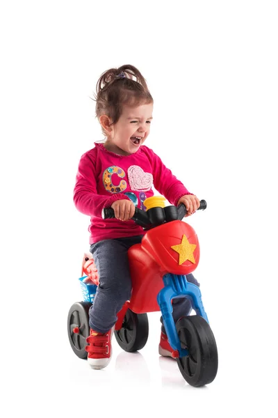 Küçük kız beyaz arka plan üzerinde izole bir motosiklet sürme — Stok fotoğraf
