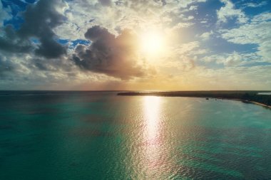 Sunriseover carribean sea and tropical island. Aerial view of Pu clipart