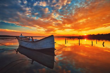 Small Dock and Boat at the lake, sunset shot clipart