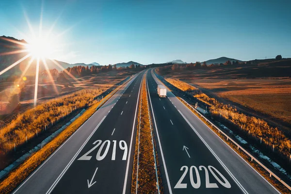 Driving on open road at beautiful sunny day to new year 2020. Aerial view — Stock Photo, Image