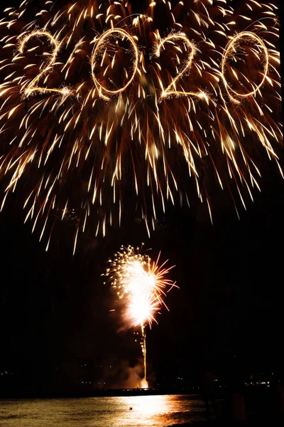 2020 escrito com fogos de artifício como pano de fundo — Fotografia de Stock