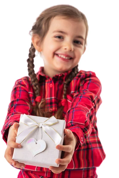 Happy little girl holding gift box in hands on white background — Stock Photo, Image