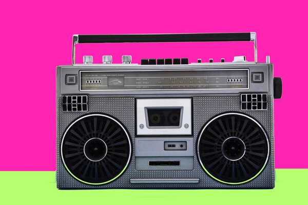 1980s Silver retro radio boom box on color background.