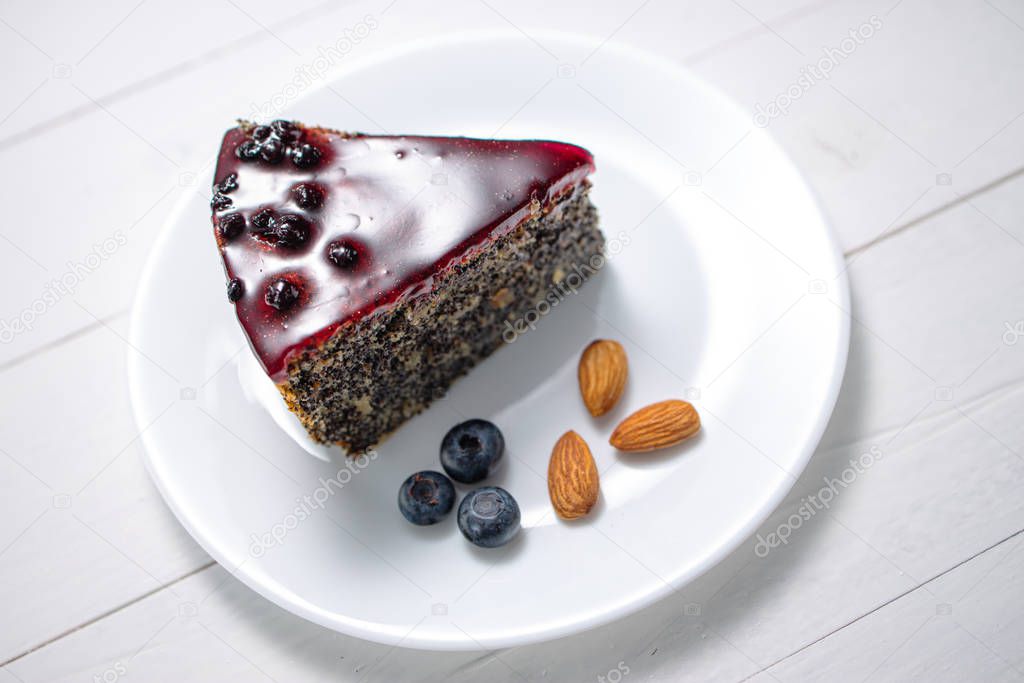 Cake with berry fruits, chia cereals and nuts isolated on wooden