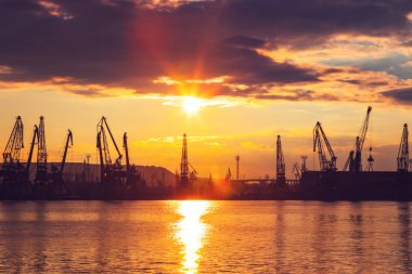 Varna, Bulgaristan 'da deniz limanı ve sanayi turnaları. Varna Gölü üzerinde gün batımı.