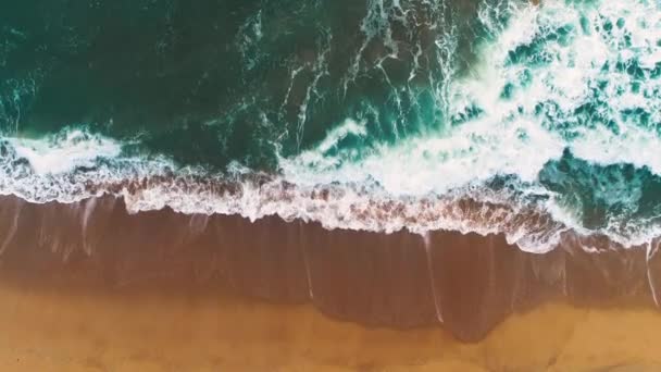 Vue aérienne des vagues de mer éclaboussant la plage. Fond bleu d'eau