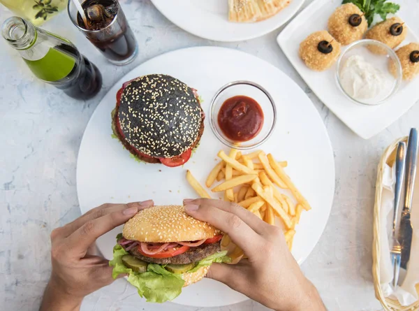 Man eating burgers