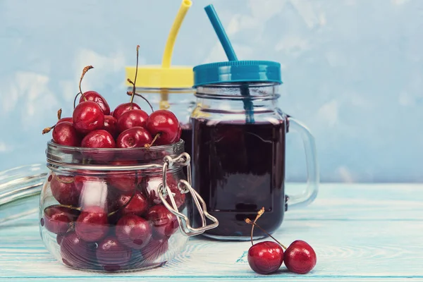 Cherry juice with glass of berries — Stock Photo, Image