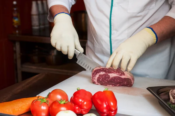 Chef cutting meat — Stock Photo, Image