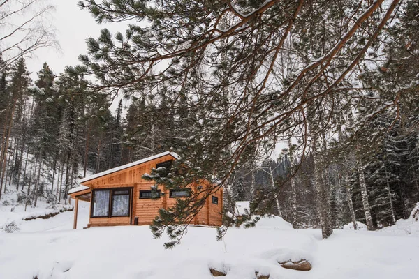 Winter holiday house in forest.