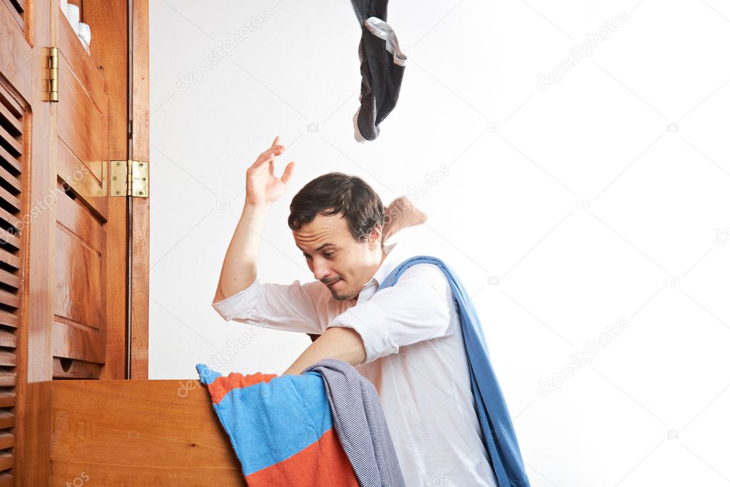 man throwing clothes in air