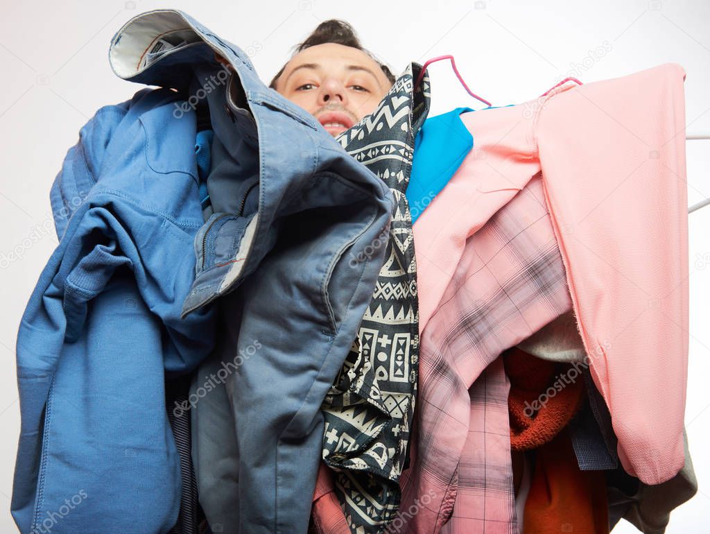 Man covered of stack clothes