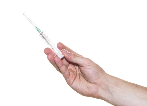 Ruka držící injekční stříkačky s jehlou izolované na bílém — Stock fotografie