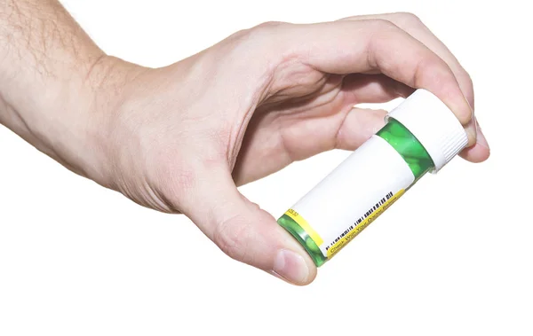 白い背景の上の手で錠剤容器 — ストック写真