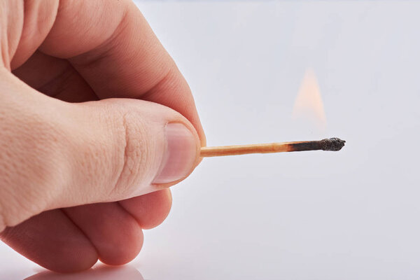 горящая спичка в руке
