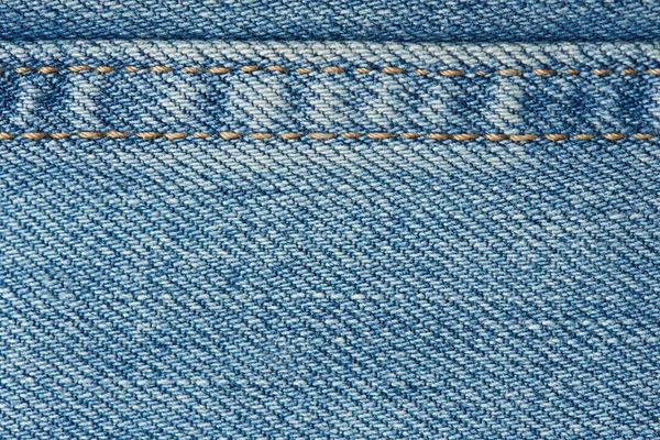 Stitches on light blue jeans background — Stock Photo, Image