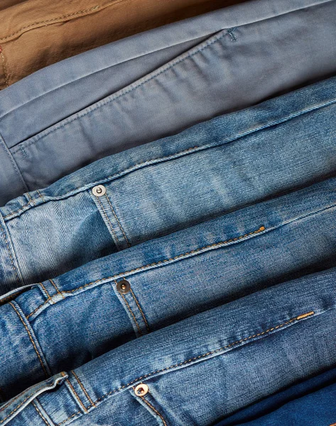 Pile of different color jeans